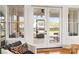 Sunroom with neutral decor, beautiful french doors, and windows overlooking the backyard at 211 Killian Rd, Stanley, NC 28164