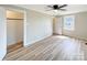 Comfortable bedroom with wood floors, closet, ceiling fan, and natural light at 2210 22Nd Avenue Se Ct, Hickory, NC 28602