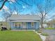 Charming home featuring a covered porch, metal roof, manicured lawn and stone landscaping elements at 2210 22Nd Avenue Se Ct, Hickory, NC 28602