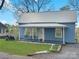 Charming light blue home featuring a metal roof and inviting covered front porch at 2210 22Nd Avenue Se Ct, Hickory, NC 28602