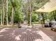 Large wooden deck surrounded by trees and lush greenery, perfect for outdoor relaxation at 2248 Lawton Bluff Rd, Charlotte, NC 28226