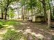 Large backyard with a storage shed and lots of room to roam; the main house can be seen in the background at 2248 Lawton Bluff Rd, Charlotte, NC 28226