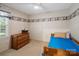 Cozy bedroom with natural light, hardwood furnishings, and nautical-themed wallpaper border at 2248 Lawton Bluff Rd, Charlotte, NC 28226