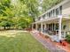 Charming front porch with seating, decorative landscaping, and a brick walkway leading to the yard at 2248 Lawton Bluff Rd, Charlotte, NC 28226