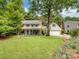 Traditional two-story home with manicured lawn, mature trees, attached garage, and American flag displayed at 2248 Lawton Bluff Rd, Charlotte, NC 28226