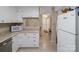 Bright kitchen featuring white cabinetry, tile floors, and modern appliances with an open view to the home's entry at 2248 Lawton Bluff Rd, Charlotte, NC 28226