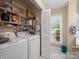 Convenient laundry room with a washer, dryer, and storage shelves, maximizing functionality at 2248 Lawton Bluff Rd, Charlotte, NC 28226
