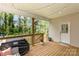 Relaxing covered back porch with comfortable seating and wood railings with backyard views at 2402 Winfield St, Kannapolis, NC 28083