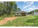 View of the house's backyard and deck area with a grassy hill at 2402 Winfield St, Kannapolis, NC 28083