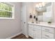 Bathroom features a modern vanity, mirror, and ample lighting with an exterior window at 2402 Winfield St, Kannapolis, NC 28083