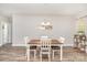 Dining room featuring a wood table with white chairs and a modern light fixture, creating an inviting space at 2402 Winfield St, Kannapolis, NC 28083