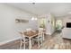 Cozy dining area featuring wood flooring and a table with four chairs, adjacent to a living space at 2402 Winfield St, Kannapolis, NC 28083