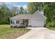 Charming single-story home featuring a welcoming front porch and a well-maintained front yard with an attached garage at 2402 Winfield St, Kannapolis, NC 28083