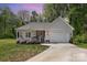 Charming single-story home featuring a welcoming front porch and a well-maintained front yard with an attached garage at 2402 Winfield St, Kannapolis, NC 28083