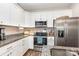 Modern kitchen with white cabinets, stainless steel appliances, and granite countertops at 2402 Winfield St, Kannapolis, NC 28083