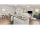 Open-concept kitchen with granite countertops, stainless steel appliances, and views of the dining and living areas at 2402 Winfield St, Kannapolis, NC 28083
