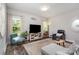 Comfortable living room with natural light, a large TV, and stylish furnishings creating a welcoming atmosphere at 2402 Winfield St, Kannapolis, NC 28083
