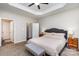 Comfortable main bedroom with a tray ceiling, ceiling fan, and views from the large windows at 2402 Winfield St, Kannapolis, NC 28083