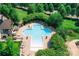 An aerial view of the community amenities featuring a cross-shaped pool and landscaped garden at 2415 Christenbury Hall Nw Dr, Concord, NC 28027
