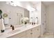Bright bathroom features a double sink vanity with neutral countertops and decor at 2415 Christenbury Hall Nw Dr, Concord, NC 28027