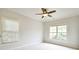 Light-filled bedroom featuring large windows, neutral decor, and plush carpeting at 2415 Christenbury Hall Nw Dr, Concord, NC 28027