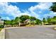 Community gated entrance with stone gatehouse, mature trees, and manicured landscaping at 2415 Christenbury Hall Nw Dr, Concord, NC 28027