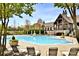 Stunning community pool with lounge chairs, and a clubhouse in a serene outdoor setting at 2415 Christenbury Hall Nw Dr, Concord, NC 28027