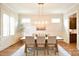 Dining room with hardwood floors, neutral walls, and a modern light fixture at 2415 Christenbury Hall Nw Dr, Concord, NC 28027