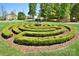 Landscaped garden maze featuring manicured hedges and a central sculpture, perfect for relaxation at 2415 Christenbury Hall Nw Dr, Concord, NC 28027