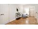 Well-lit hallway featuring hardwood floors, neutral walls, and stylish furniture at 2415 Christenbury Hall Nw Dr, Concord, NC 28027