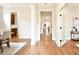 Open hallway featuring hardwood floors, white trim, and arched doorways at 2415 Christenbury Hall Nw Dr, Concord, NC 28027