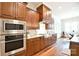 Kitchen with stainless steel appliances, custom cabinets, and hardwood floors at 2415 Christenbury Hall Nw Dr, Concord, NC 28027
