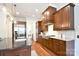Open kitchen features wood cabinets, a tile backsplash, stainless steel appliances, and granite countertops at 2415 Christenbury Hall Nw Dr, Concord, NC 28027