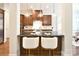Gourmet kitchen features dark cabinets, stainless steel appliances and a center island with bar seating at 2415 Christenbury Hall Nw Dr, Concord, NC 28027
