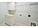 Functional laundry room equipped with a sink, cabinets, and wire shelving at 2415 Christenbury Hall Nw Dr, Concord, NC 28027