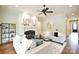 Bright living room featuring a fireplace, ceiling fan, neutral walls, and decor at 2415 Christenbury Hall Nw Dr, Concord, NC 28027