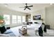 Cozy living room features a ceiling fan, built-ins, and large windows at 2415 Christenbury Hall Nw Dr, Concord, NC 28027