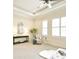 Airy main bedroom featuring a tray ceiling, fan, plantation shutters, and neutral decor at 2415 Christenbury Hall Nw Dr, Concord, NC 28027