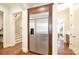 Stainless steel refrigerator framed by dark wood cabinetry in hallway near the staircase at 2415 Christenbury Hall Nw Dr, Concord, NC 28027