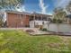 This home's backyard features a fire pit, fenced yard, and an elevated porch with stairs at 24436 Nc 24/27 Hwy, Albemarle, NC 28001