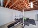 Basement gym equipped with workout equipment, including a bench press, and treadmills set against white brick walls at 24436 Nc 24/27 Hwy, Albemarle, NC 28001