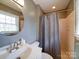 Bright bathroom with a vanity, sink, mirror, and shower/tub, featuring neutral walls and natural light at 24436 Nc 24/27 Hwy, Albemarle, NC 28001