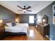 Cozy bedroom showcasing gray walls, hardwood floors, large bed, stylish decor and a large window at 24436 Nc 24/27 Hwy, Albemarle, NC 28001