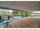 Relaxing covered deck with views of the pool and serene backyard, perfect for outdoor living at 24436 Nc 24/27 Hwy, Albemarle, NC 28001