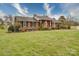 Charming single-story brick home featuring a well-kept lawn and beautiful landscaping at 24436 Nc 24/27 Hwy, Albemarle, NC 28001