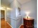 Hallway features hardwood floors, neutral wall colors, and decorative furniture, exuding subtle elegance at 24436 Nc 24/27 Hwy, Albemarle, NC 28001