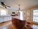 Bright and spacious kitchen with a large island, hardwood floors, and modern appliances under a ceiling fan at 24436 Nc 24/27 Hwy, Albemarle, NC 28001