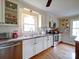 Well-lit kitchen featuring white cabinetry, hardwood floors, stainless steel appliances, and a cozy breakfast bar at 24436 Nc 24/27 Hwy, Albemarle, NC 28001