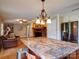 Open floor plan featuring a kitchen island, brick fireplace, and seamless transition to the living area with ceiling fan at 24436 Nc 24/27 Hwy, Albemarle, NC 28001