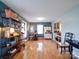 Open living space with hardwood floors, bright natural light, eclectic decor, and cozy dining nook at 24436 Nc 24/27 Hwy, Albemarle, NC 28001